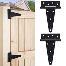 Long black strap hinges attached to a wooden barn door