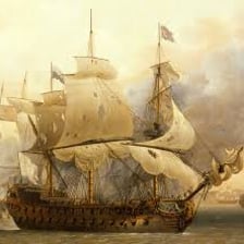 A naval fleet of ships sailing at sea.