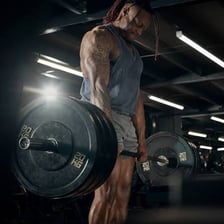 A person performing a squat during a leg workout.