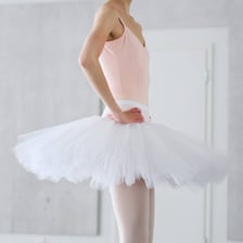 A classical ballerina wearing a white tutu