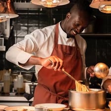 A chef preparing ingredients on a kitchen counter.