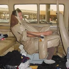 A passenger sitting in the front seat of a car.