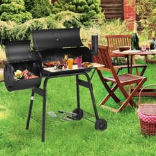 A backyard patio with a barbecue grill