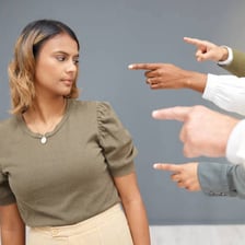 A person expressing disapproval with a pursed-lip gesture