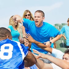 Crowd members heckling during a sporting event