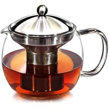 Loose tea leaves steeping in a glass teapot