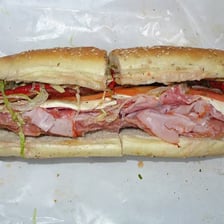 A long deli hero sandwich on a roll