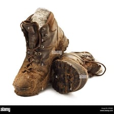 Hiking boots covered in dried mud