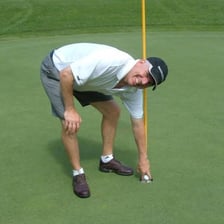 A golfer taking a shot on a golf course