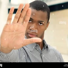 A person holding up a hand to signal that they do not want to hear more