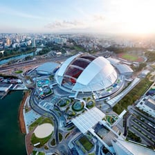 A sports stadium with a large domed roof.