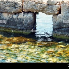 An opening or breach in a stone wall.