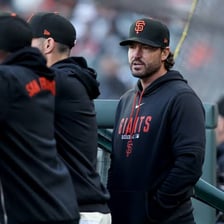 A Major League Baseball manager standing in a team dugout.
