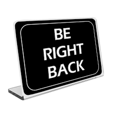 A desk sign indicating a temporary or acting position.