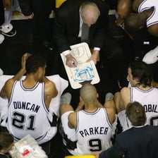 Basketball players huddling during a timeout