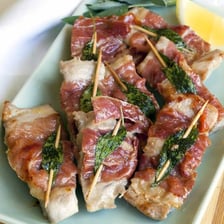 A veal saltimbocca dish topped with prosciutto and sage.