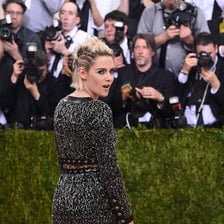 Celebrities posing on a red carpet before photographers