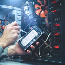 A computer technician troubleshooting a desktop computer.