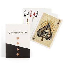 An ace of spades playing card beside a garden spade.