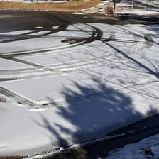 Tire tracks showing a vehicle making a sharp turn.