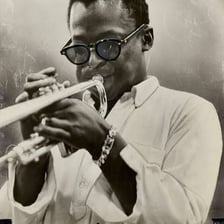 Miles Davis performing on trumpet.