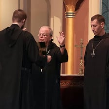 An abbot wearing monastic robes inside a monastery