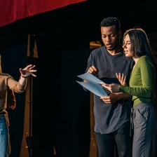 A theater actor addressing the audience from the stage