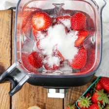 A blender turning fruit into a smooth purée.