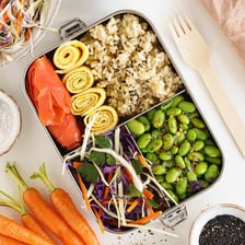 A Japanese bento box containing several arranged foods.