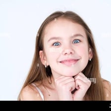 A person giving a playful, mischievous smile.