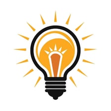 A light bulb visibly giving off rays of light