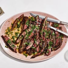 Sliced grilled carne asada served on a plate.
