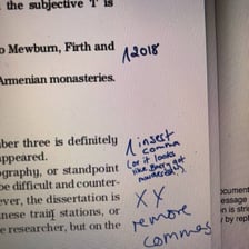 An editor reviewing and marking up a manuscript for publication