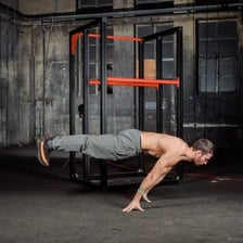 A person holding the body straight in a forearm plank.