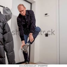 A person taking off a coat in a changing area