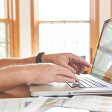 A person monitoring information on a computer