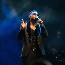 A performer holding a microphone on stage