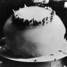 A historical photograph of a nuclear test explosion near Bikini Atoll