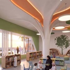 A calm library interior with bookshelves and reading tables.