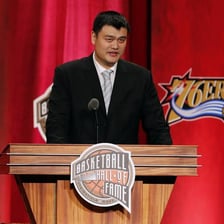 Yao Ming standing on a basketball court.