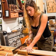 Several hand saws arranged in a carpenter’s workshop.