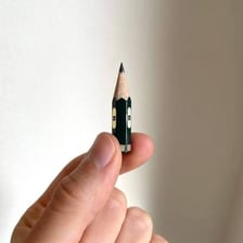 A short worn-down pencil stub on a desk