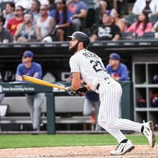A baseball batter standing at home plate.