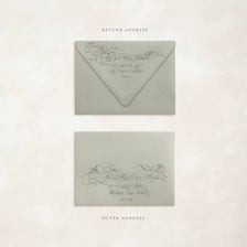 A handwritten letter being placed into an envelope