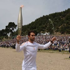 The Olympic flame burning in a ceremonial torch