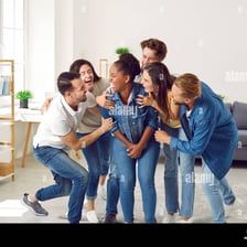 Friends laughing together at a particularly funny person.