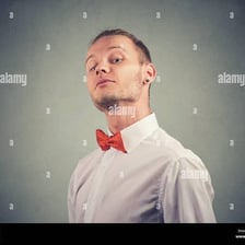 A formal portrait of a person posing with an overly self-important expression.