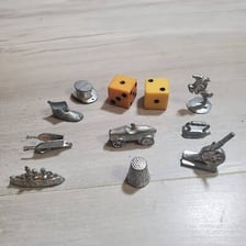 Classic Monopoly playing tokens displayed together