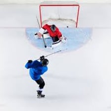 A hockey player faking past a defender on the ice