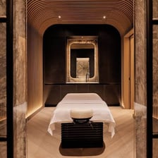 A tranquil spa treatment room with a massage table and relaxing decor